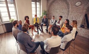people sitting in a circle in group therapy program