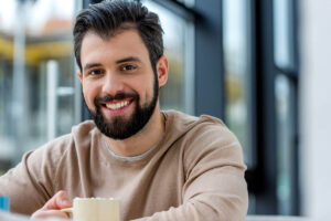 Smiling bearded man considers the benefits of an outpatient treatment program