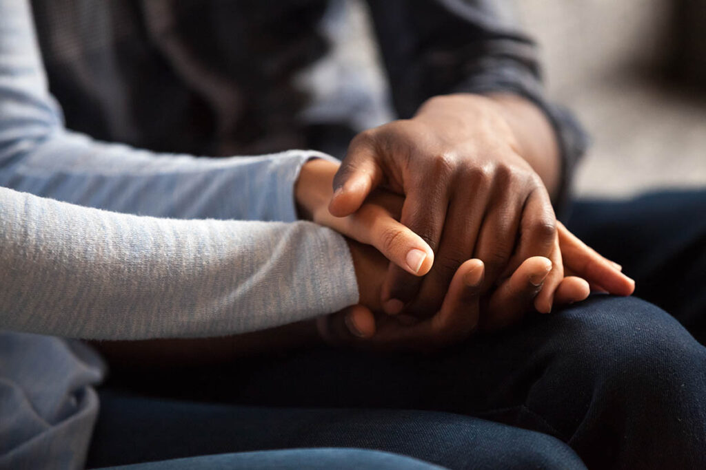 holding hands and learning about supporting someone with ptsd