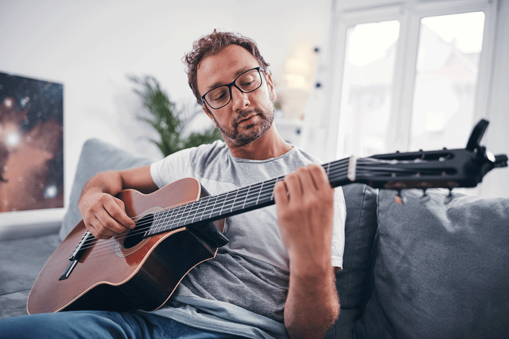 a man plays guitar in his music therapy program for addiction treatment