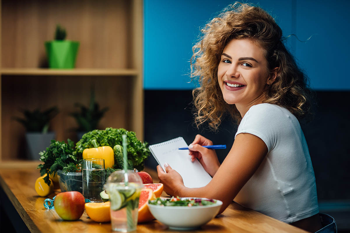 woman with curly hair eating veggies considers the role of diet in addiction recovery