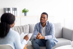 man on couch talks with therapist about suboxone addiction treatment 