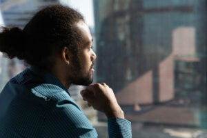 man looks out of the window and considers is suboxone addictive